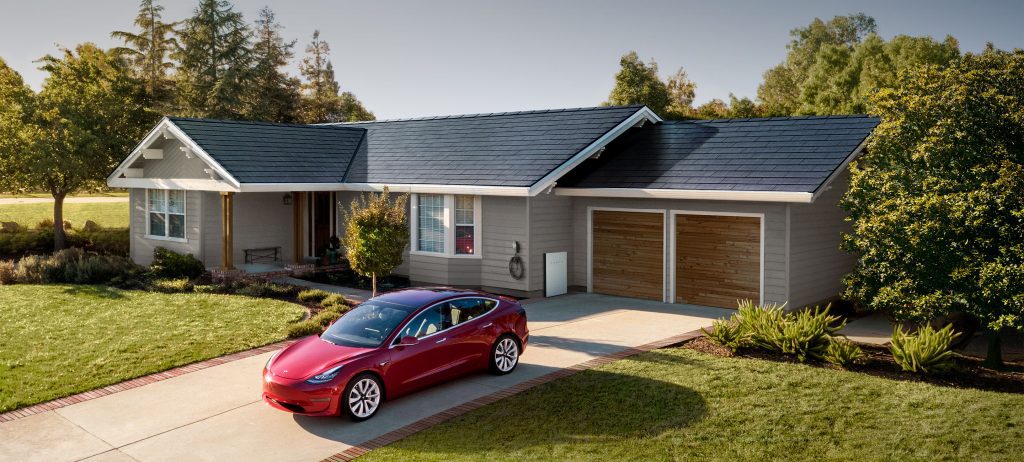 Tesla in front of house